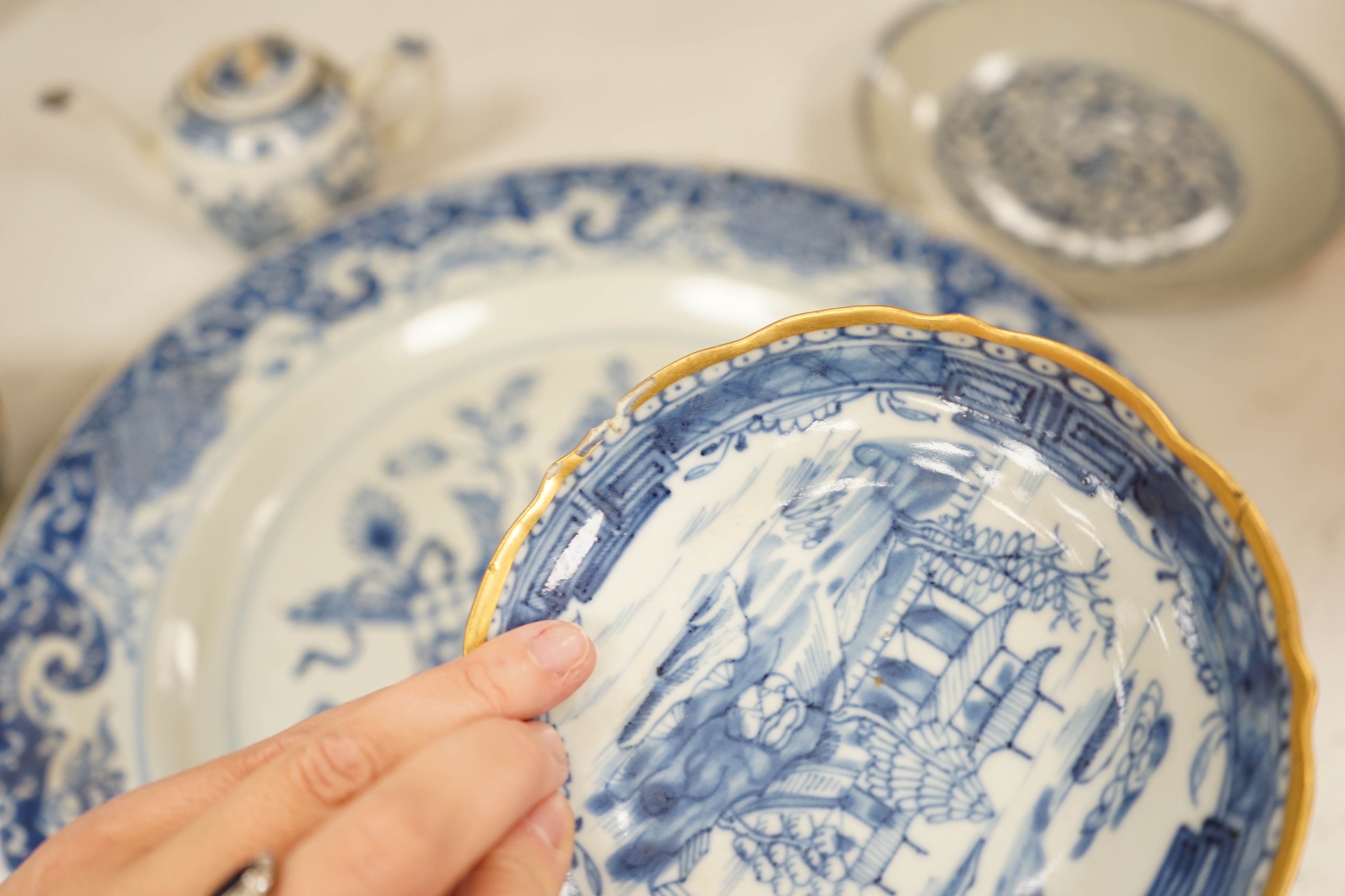 A Worcester teapot, c.1770, two 18th century Chinese porcelain dishes, a cup and saucer, a Chinese shallow bowl and a small teapot, largest dish 39cm